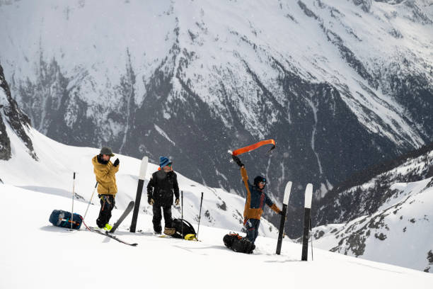 istock Backcountry skiers prepare to ski down mountain 2150396555