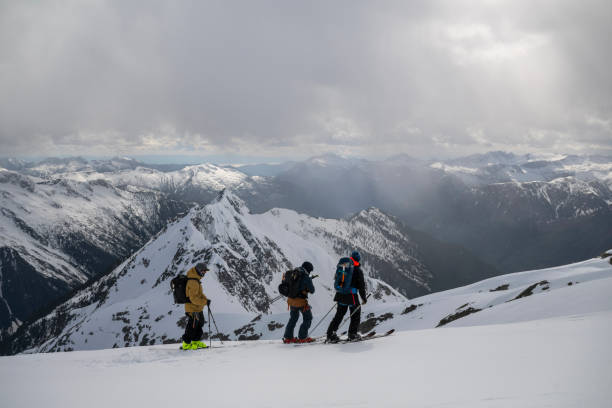 istock Backcountry skiers climb mountain 2150396560
