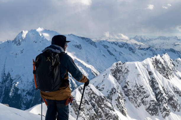istock Backcountry skier climbs mountain 2150396570
