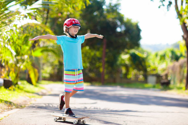 istock Kid with skateboard. Child riding skate board. 2150398219