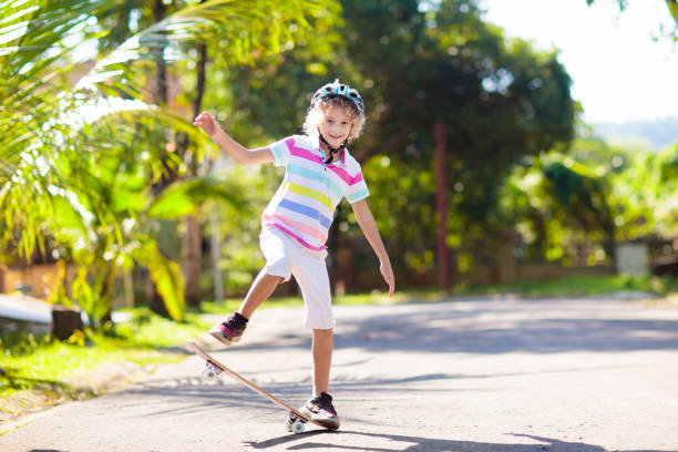 istock Kid with skateboard. Child riding skate board. 2150398327