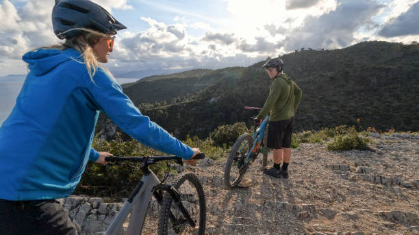 istock E-mountain bicyclists pause on mountain top 2150398696