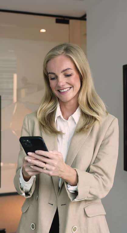 Pretty businesswoman solving business matter remotely using modern smartphone