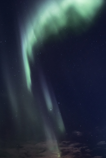 Northern lights with stars on clear sky.