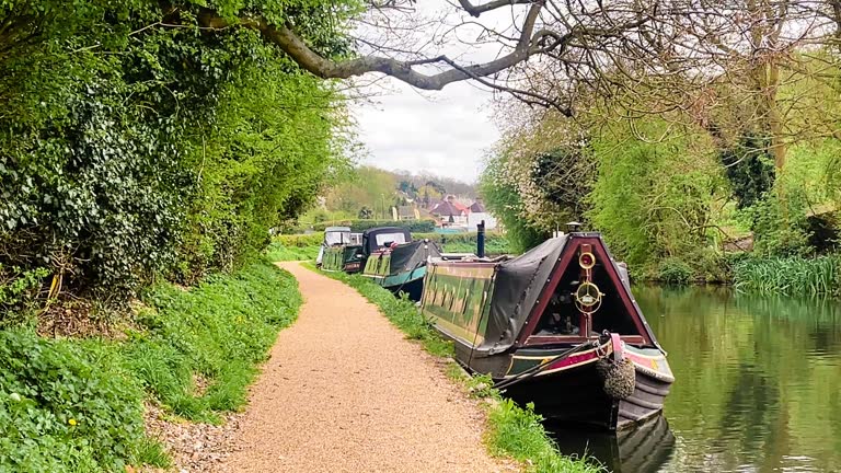 Scenic view of canal boat and picturesque waterway, surrounded by lush greenery and quaint countryside in Apsley, Hertfordshire, England, United Kingdom