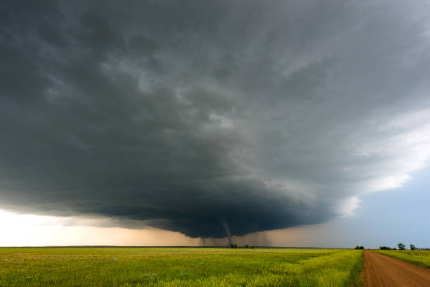 istock Distant Tornado Under Dark Storm Clouds Along A Dusty Road 2150399425
