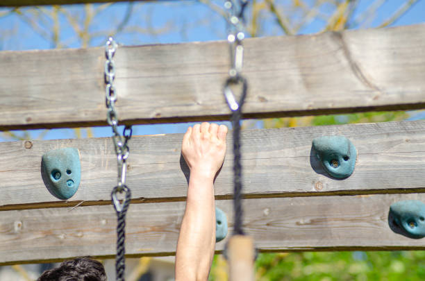 athlete hand at a hanging obstacle at an obstacle course race, OCR