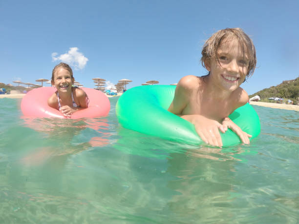 istock Young caucasian children floating in the sea 2150401149
