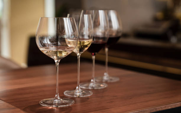 istock Wine glasses in a row. Glasses with different wines on wooden table. 2150402680
