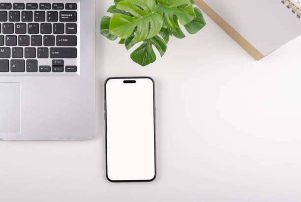 istock Smartphone and laptop on white background with beautifully decorated plants. 2150409672