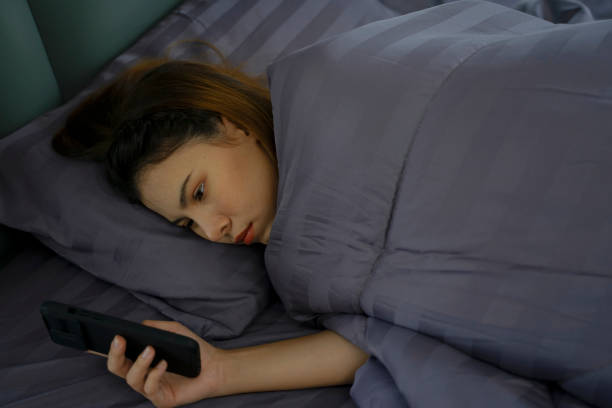 istock Pretty woman is playing her smart phone after wake up. 2150409895