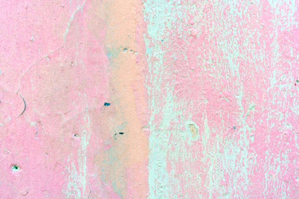 The weathered pink painted cement wall background