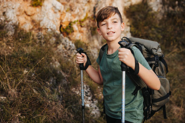 istock Boy with hiking equipment on rocky mountain 2150410093