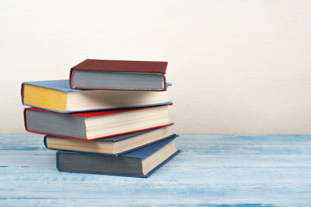 istock Book stacking, hardback books on wooden table. Back to school. Copy space for text 2150411676
