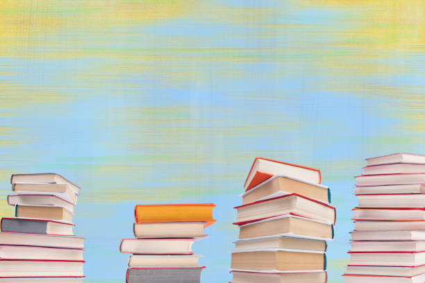 Composition with hardback books on wooden deck table and blue background. Books stacking. Back to school. Copy Space. Education background
