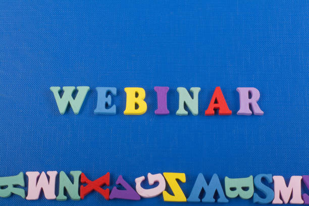 istock WEBINAR word on blue background composed from colorful abc alphabet block wooden letters, copy space for ad text. Learning english concept. 2150412525