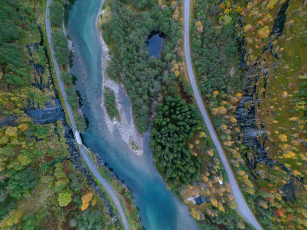 istock River by country road, flowing gently through plants 2150412641