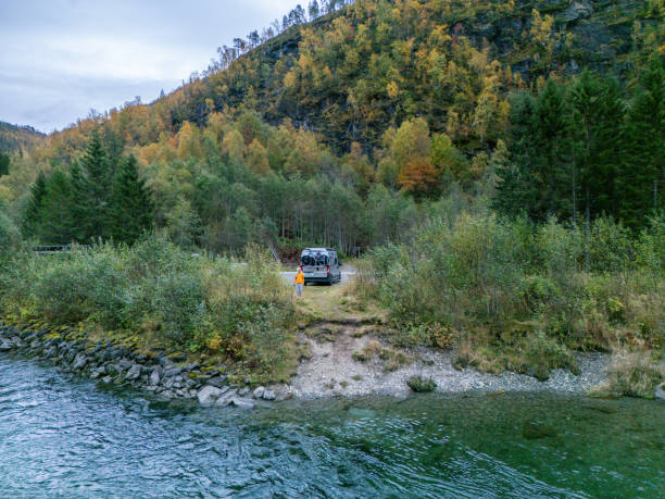 istock Off-Road Vehicle by a Mountain River in Autumn 2150412644