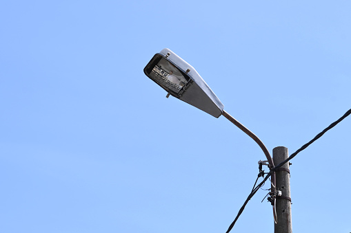 Close-up of a broken street lamp on a pole