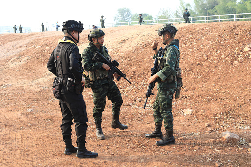 Mae Sot, Tak, Thailand - April 23, 2024 : Thai soldiers with weapons is stationing at the strategic location of the 2nd Friendship Bridge border Thailand, Mae Sot, Tak.