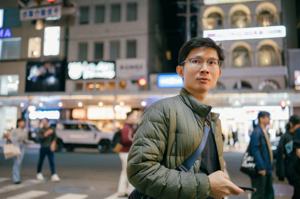 istock 30S japanese businessmen using mobilephone mobile application searching for location from AI smart data to travel alone in Osaka japan 2150424174