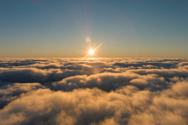 istock Sunlight piercing through cumulus clouds in the sky 2150424624