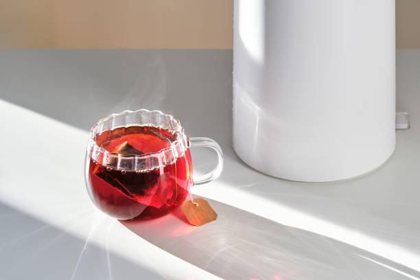 istock Glass mug with hot black tea on the table. 2150428399