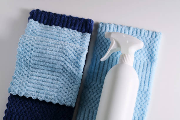 istock Cleaning product with a sprayer on a background of a blue microfiber cloth. 2150428929