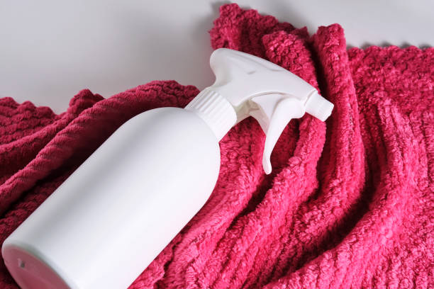 istock Cleaning product with a sprayer on a background of a red microfiber cloth. 2150428980