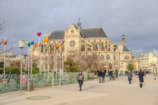 Paris, France Paris, France - December 29, 2023: Pedestrians passing by Saint-Eustache Church on a stormy day. HDR encoded église saint eustache stock pictures, royalty-free photos & images