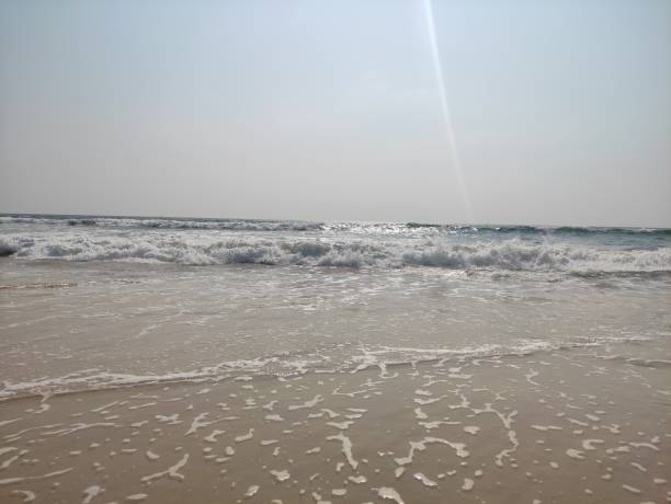 istock Beach with waves and sun glare. 2150431346