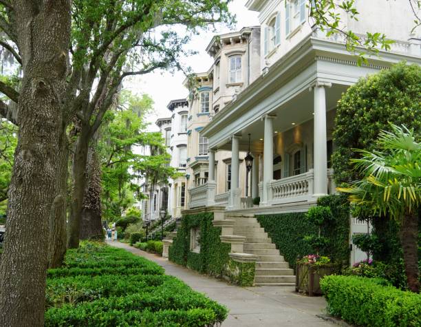 Savannah GA April 2024 Stately elegant homes in the Historic District  shaded by Live oak trees and lush greenery