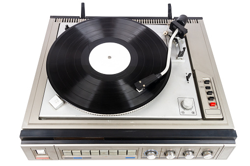 Vintage turntable record player with black vinyl isolated on white background.