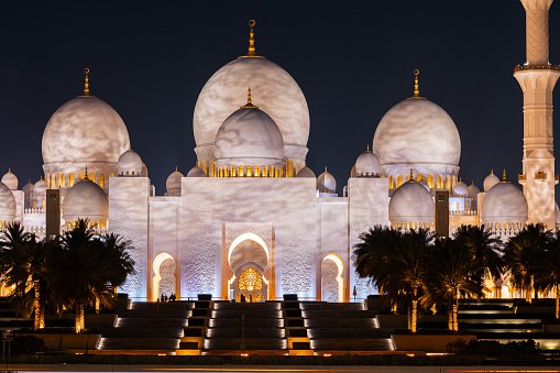 Abu Dhabi, UAE - April 23, 2024: Sheikh Zayed Mosque's domes and columns at night