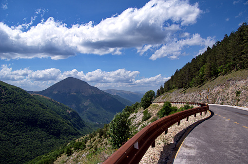 view of mountain road against forest and sky