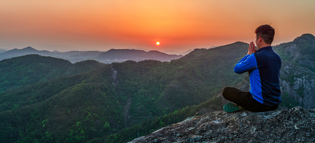 Meditation on the mountaintop under the sunset