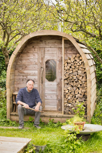 istock Senior man sitting outside his homemade sauna 2150438087