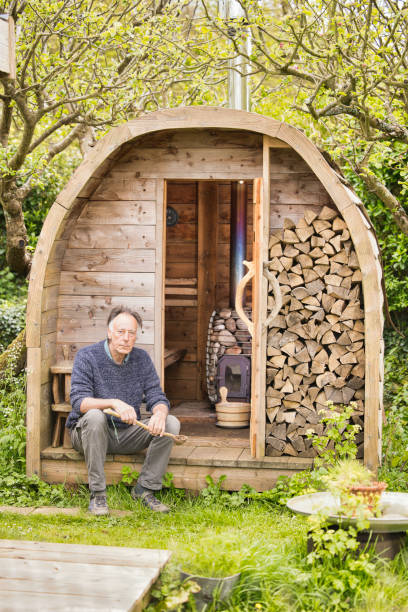 istock Senior man sitting outside his homemade sauna 2150438128