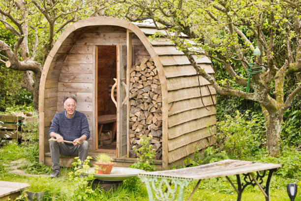 istock Senior man sitting outside his homemade sauna 2150438245