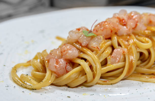 Linguine pasta with peeled praws stock photo