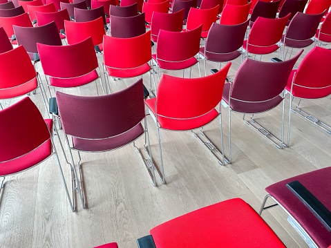 rows of chairs in different shades of red
