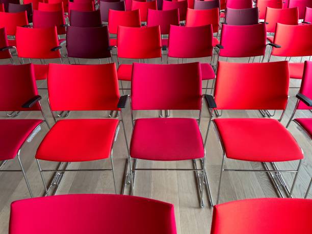 istock rows of chairs in different shades of red 2150445120