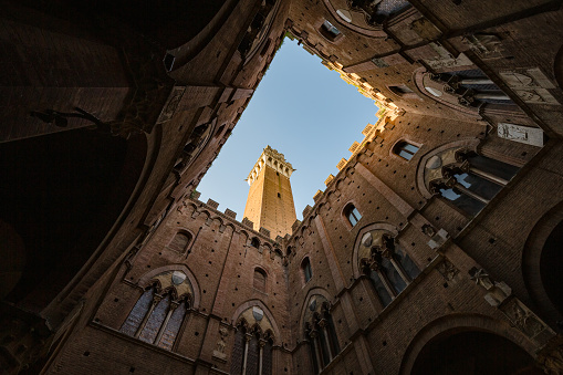 Siena, Italy  may, 2022: view of sky from internal court in Palazzo Pubblico Siena, Italy. Bell tower- Torre del Mangia look in window