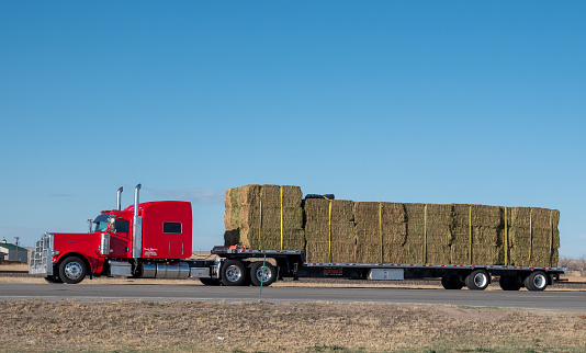 Limon, Colorado, USA- April 10, 2024: Large semi truck loaded with one ton bales of hay.