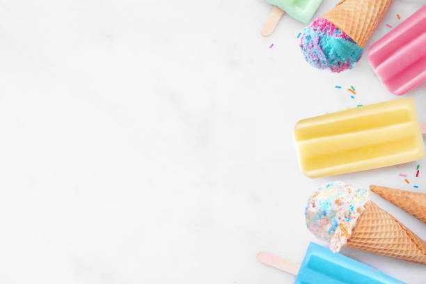 istock Colorful pastel ice cream cones and summer popsicle side border on a white marble background 2150446684