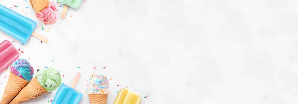 istock Colorful pastel ice cream cone and summer popsicle  corner border on a white marble banner background 2150446876