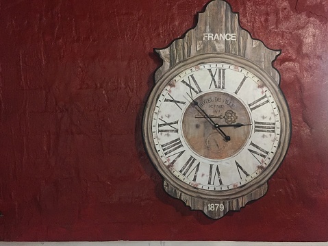 French clock on a red wall
