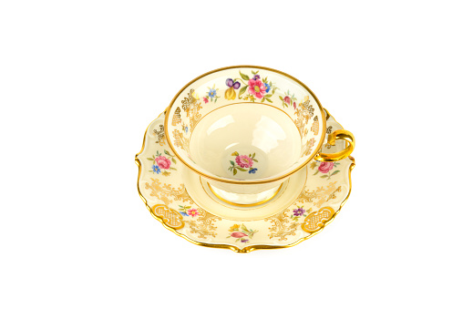 Vintage porcelain cups and saucer isolated on white background.