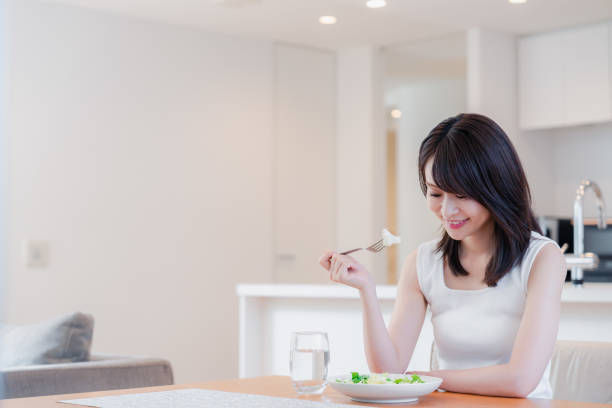istock Young woman eating Lunch at home 2150450126
