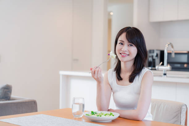 istock Young woman eating Lunch at home 2150450127